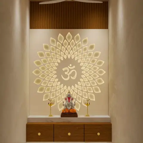 Render of a pooja room niche with a backlit CNC-cut lotus-and-Om wall panel above a marble-topped wood cabinet holding a Ganesh idol, under a wood-slat ceiling.
