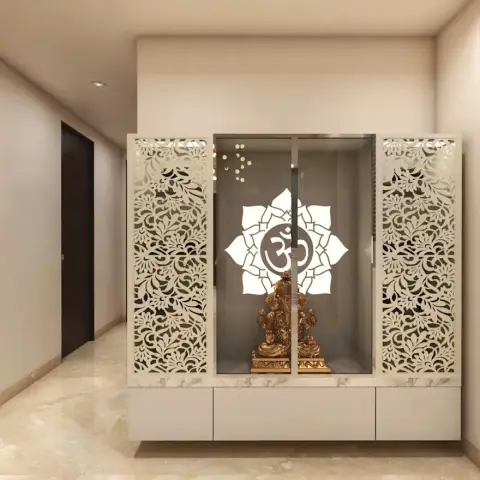 Render of a pooja unit with intricate white CNC-cut floral jaali doors, a glass panel etched with a lotus Om motif, and a brass Ganesh idol inside.