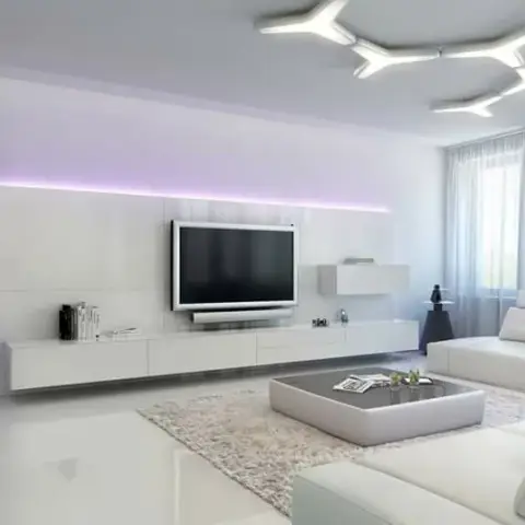 Render of an all-white living room with a purple-backlit TV wall, sculptural branched ceiling light and a white sectional sofa.