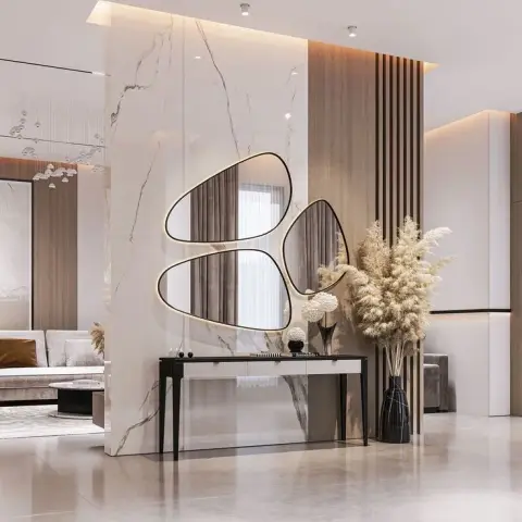 Render of an entry foyer built around a full-height veined marble partition carrying three organic pebble-shaped backlit mirrors, with a slim black console