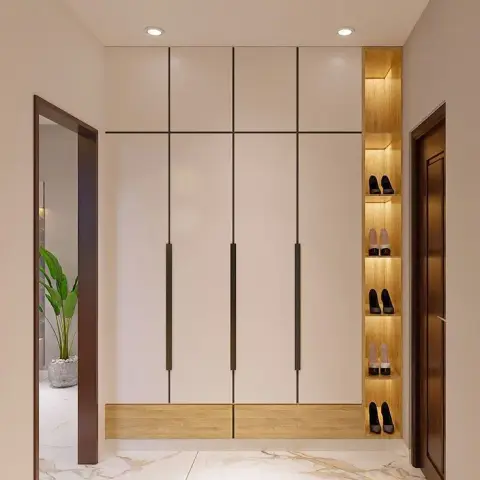 Render of an entry lobby dominated by a floor-to-ceiling cream storage unit with long bronze handle profiles and an oak plinth