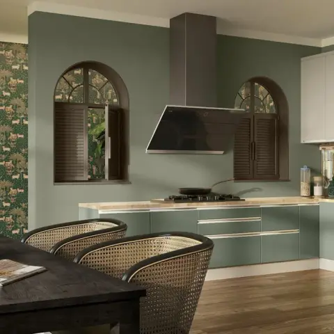 Render of an open kitchen-dining space with sage-green cabinetry, arched shuttered windows, a chimney hood and a wildlife-print wallpaper accent wall.