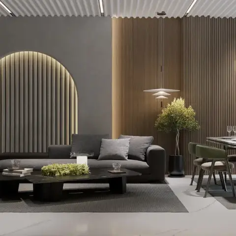 Render of an open living-dining-kitchen in browns and greys: a deep brown modular sofa faces a backlit fluted arch niche in a grey plaster wall