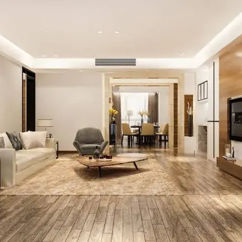 Render of an open living room with a cream sofa and round wooden coffee table on a jute-toned rug, a wood-clad TV wall to the right