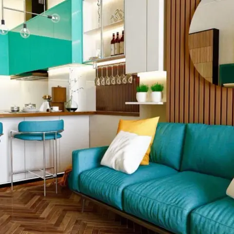 Render of an open-plan kitchen-living space with teal gloss wall cabinets over a white breakfast bar