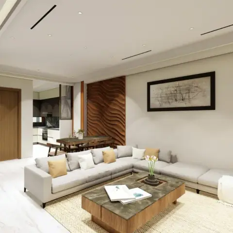 Render of an open-plan living room where a grey L-sofa with mustard cushions faces a low stone-top table on jute