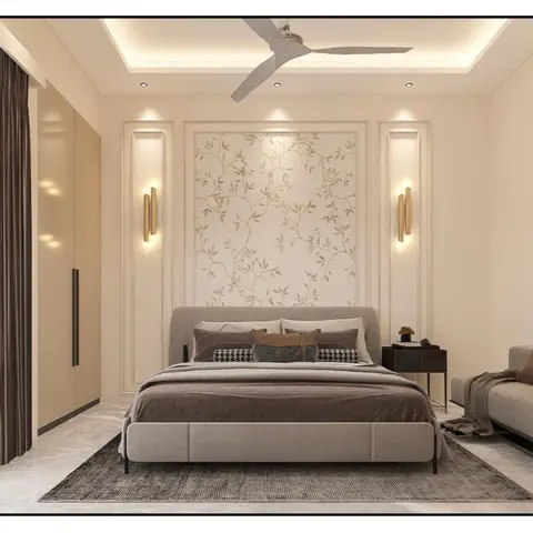 Rendered bedroom with a botanical vine wallpaper panel framed in moulding above an upholstered grey bed, twin brass tube wall sconces, a cove-lit ceiling fan