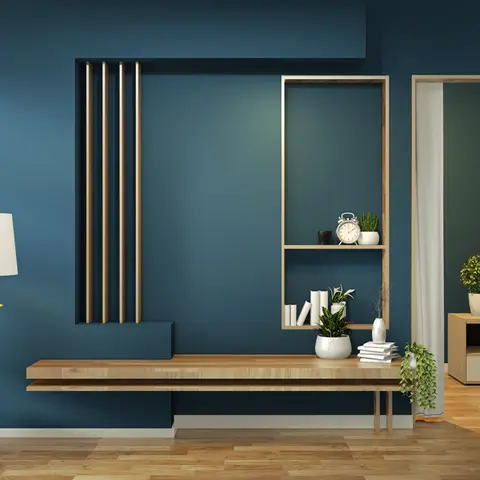 Rendered living room wall in deep navy blue with a floating wood console and an asymmetric ladder shelf styled with books, a clock and potted plants