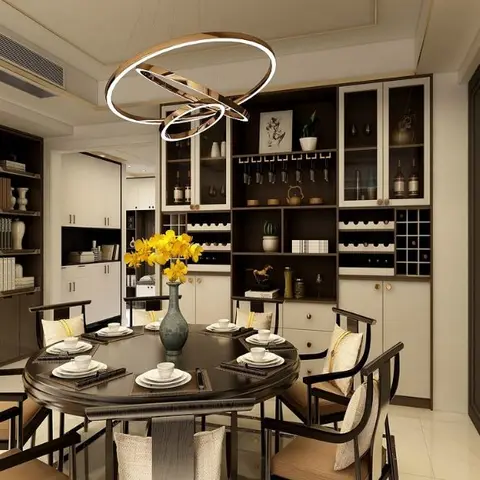Round dark-wood dining table for eight beneath a ring-form pendant light, with a full-wall crockery and wine display unit behind