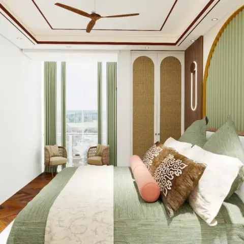 Sage-green arched fluted headboard panel outlined in brass, facing a white 3D-textured TV wall