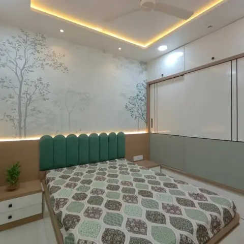 Sage-green arched fluted headboard set against a misty tree-mural wallpaper with a lit strip behind it