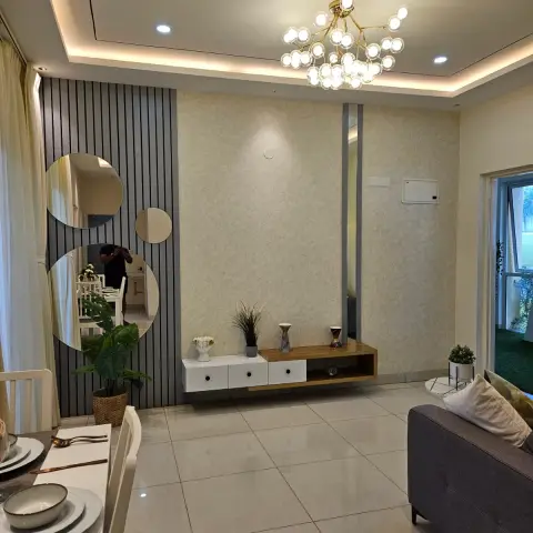 Show-flat photo of a living room with three round frameless mirrors mounted on a dark grey fluted panel