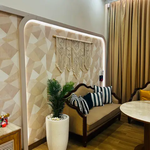 Sitting nook with a backlit arched wallpaper panel in a beige geometric pattern, a macrame wall hanging