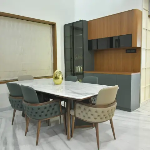 Six-seat dining with a white marble-top table and button-tufted teal and beige chairs on tapered teak legs