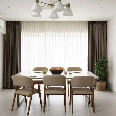Six-seater dining room shot straight into a blown-out sheer-curtained window, taupe leather-look chairs on splayed wood legs and a six-arm brass-and-white cone