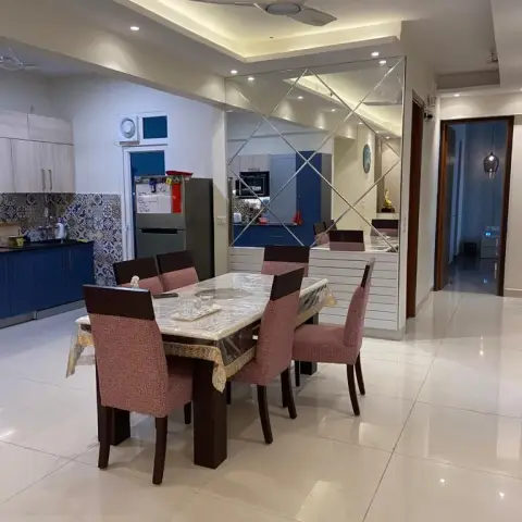 Six-seater dining set on glossy ivory tiles against a diamond-bevelled mirror wall