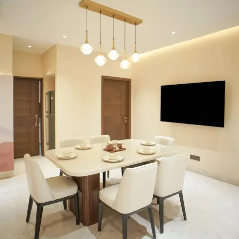 Six-seater dining table with a cream stone top on a fluted walnut pedestal, cream leather chairs on dark metal legs