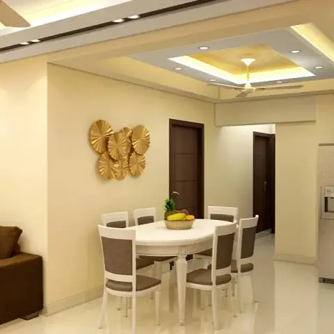Six-seater oval white dining table under a rectangular gold-lined cove tray ceiling