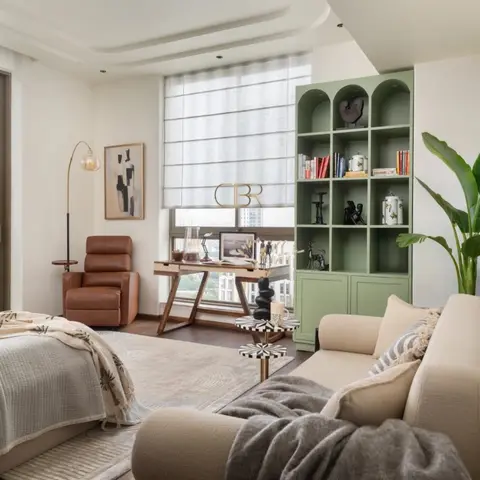 Studio-style room combining a bed nook, a cognac leather recliner, a wood X-frame desk by the window