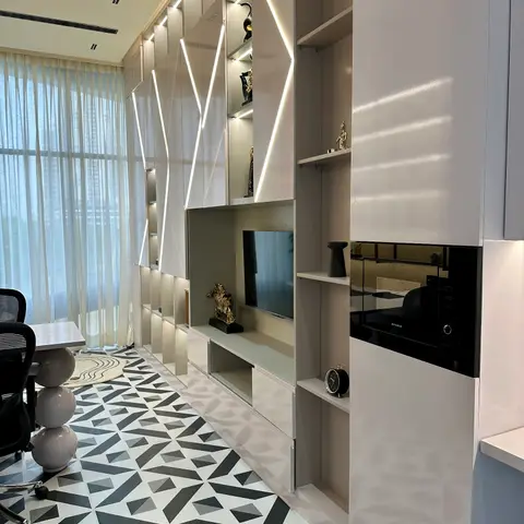 Study/media wall with a diamond-patterned LED-lit display and TV niche, a built-in microwave, and a bold black-and-white geometric floor tile.