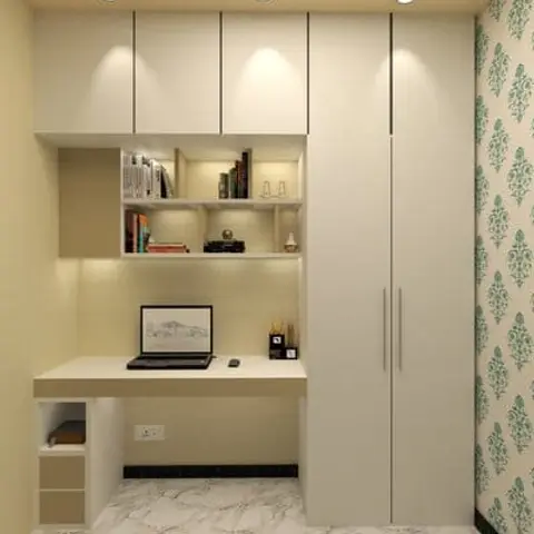 Study nook with a built-in desk, overhead open shelving, and an adjacent tall wardrobe against a floral wallpaper accent wall.
