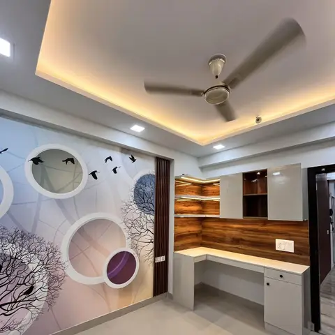 Study nook with a custom bird-and-bare-tree mural wallpaper feature wall and an L-shaped desk with a walnut-finish backsplash and LED-lit corner shelving