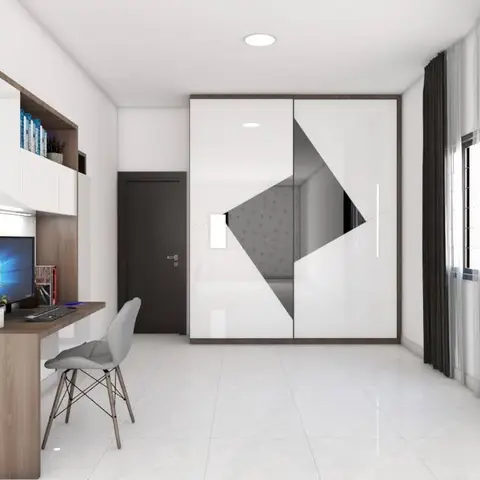 Study nook with a wall-mounted desk and monitor beside a wardrobe with a geometric mirror-panel inlay.
