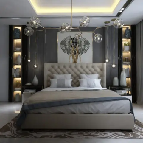 Symmetric bedroom with a button-tufted beige headboard, matching backlit open display niches flanking the bed