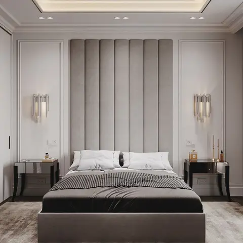 Symmetric master bedroom with a floor-to-ceiling channel-tufted headboard flanked by crystal wall sconces and mirrored nightstands.