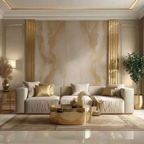 Symmetrical cream living room built around a gold-veined marble slab wall flanked by two fluted brass columns, with a low cream sofa