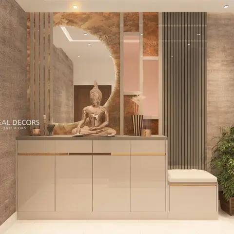 Taupe gloss shoe cabinet with brass trim beneath an arched mirror and a gold Buddha statue, flanked by a textured wallpaper and fluted panel wall.