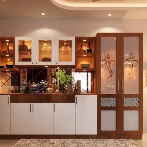 Teak-and-white crockery-cum-bar unit with lit corner niches over a diamond-bevel mirror backsplash