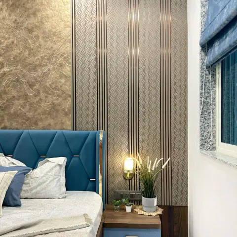 Teal diamond-stitched wing headboard beside a basketweave wallpaper panel split by rose-gold reveal strips