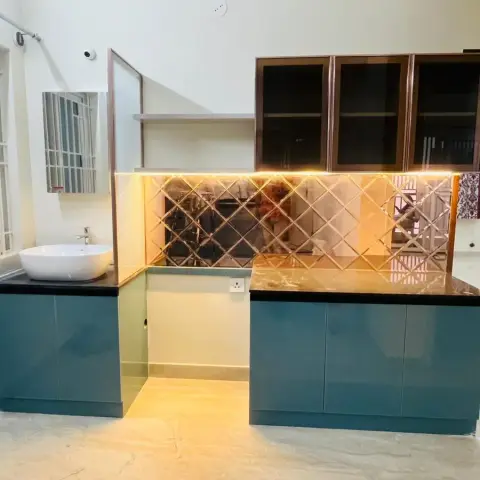 Teal high-gloss crockery-and-washbasin run with black granite tops, a diamond-bevelled mirror backsplash and smoked glass overhead shutters