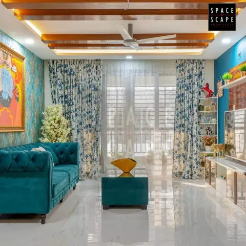 Teal velvet chesterfield and a matching upholstered coffee table holding a gold sculptural bowl