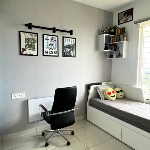 Teen's bedroom with a textured grey accent wall hung with a framed poster gallery on a rail, and a white daybed with built-in storage drawers below the window.