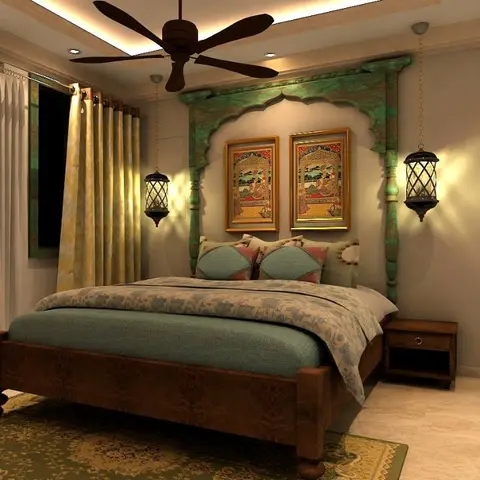 Traditional Indian bedroom with a hand-carved teal archway headboard flanked by hanging lanterns, framed miniature paintings