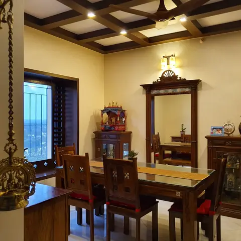 Traditional Indian dining room with a carved teak dining set, a coffered wood ceiling