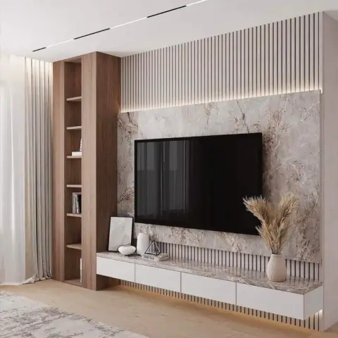 TV feature wall with a beige-veined marble backdrop, vertical wood slat cladding, an open wood shelving column and a floating white drawer console