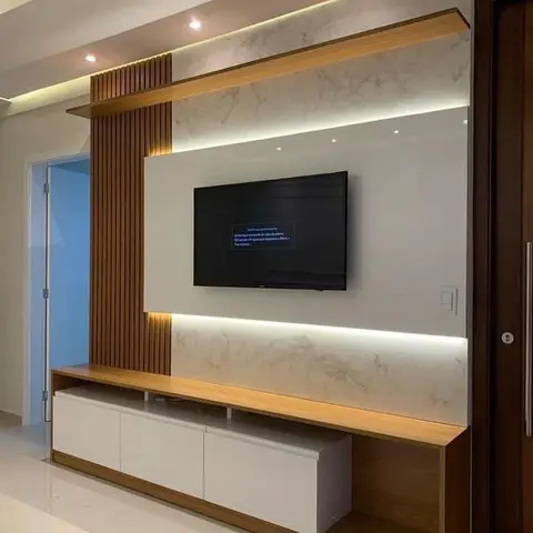 TV feature wall with a book-matched marble panel backlit with LED strips, vertical wood-slat accent and a floating wood-and-white TV console.
