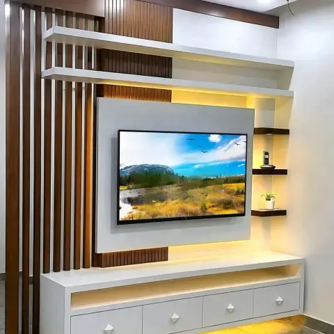 TV feature wall with a fluted wood-slat partition screen, warm backlit display shelving, and a white drawer console below.