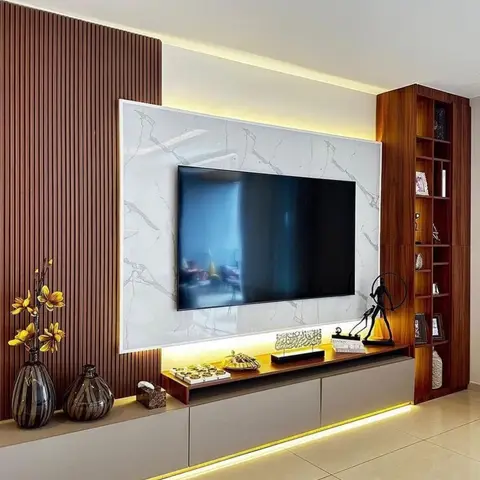 TV feature wall with a white-veined marble panel flanked by fluted wood panelling, a floating backlit media console