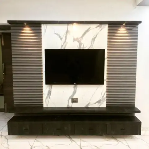 TV feature wall with dark ribbed wood panelling framing a bookmatched marble slab and a floating drawer console.