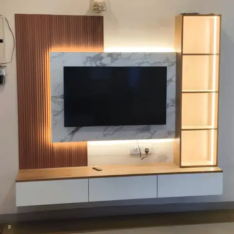 TV feature wall with vertical fluted wood panelling beside a marble-look backdrop, a floating wood-top cabinet, and a backlit vertical wood display shelf