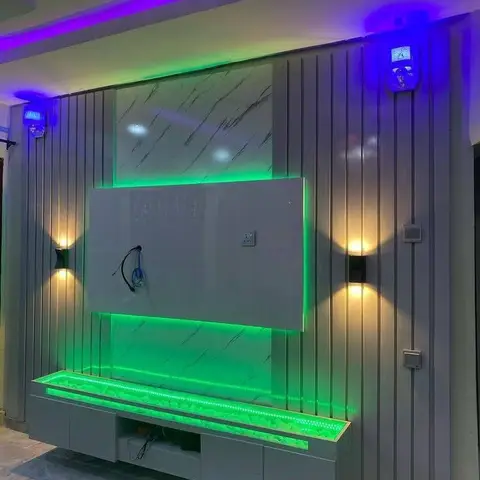 TV feature wall with vertical fluted grey panelling, a floating backlit marble-effect panel