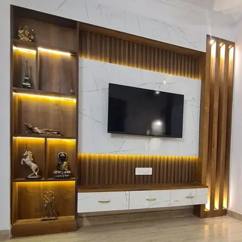 TV feature wall with vertical fluted wood panelling and veined marble backdrop, flanked by a backlit display shelf styled with curio figurines.
