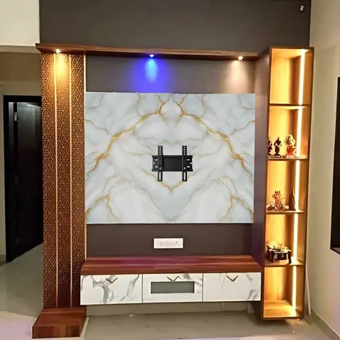 TV point with a gold-veined marble-effect backsplash panel flanked by a CNC-jaali wooden pilaster and a backlit display shelf of curios.
