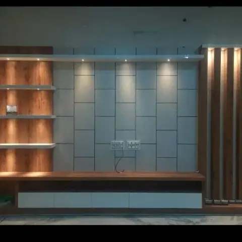 TV unit wall combining a walnut-finish open shelving unit, staggered white wall tiles with spotlights, and a backlit fluted wood panel section.