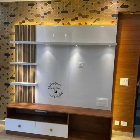 TV unit wall with a geometric gold-and-brown mosaic tile backdrop, a glossy white panel with floating fluted shelves