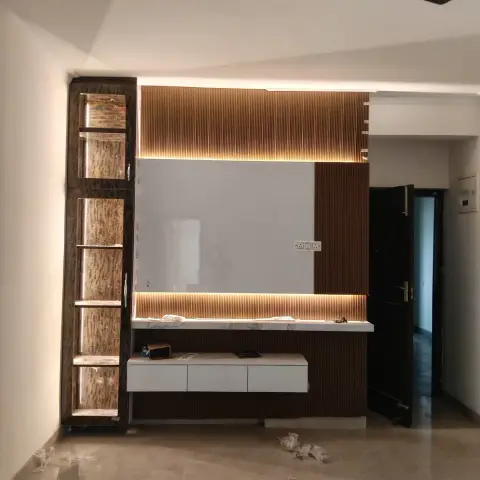 TV wall combining a mirror-panel center flanked by backlit fluted wood cladding, with a floating white console and matching tall display unit